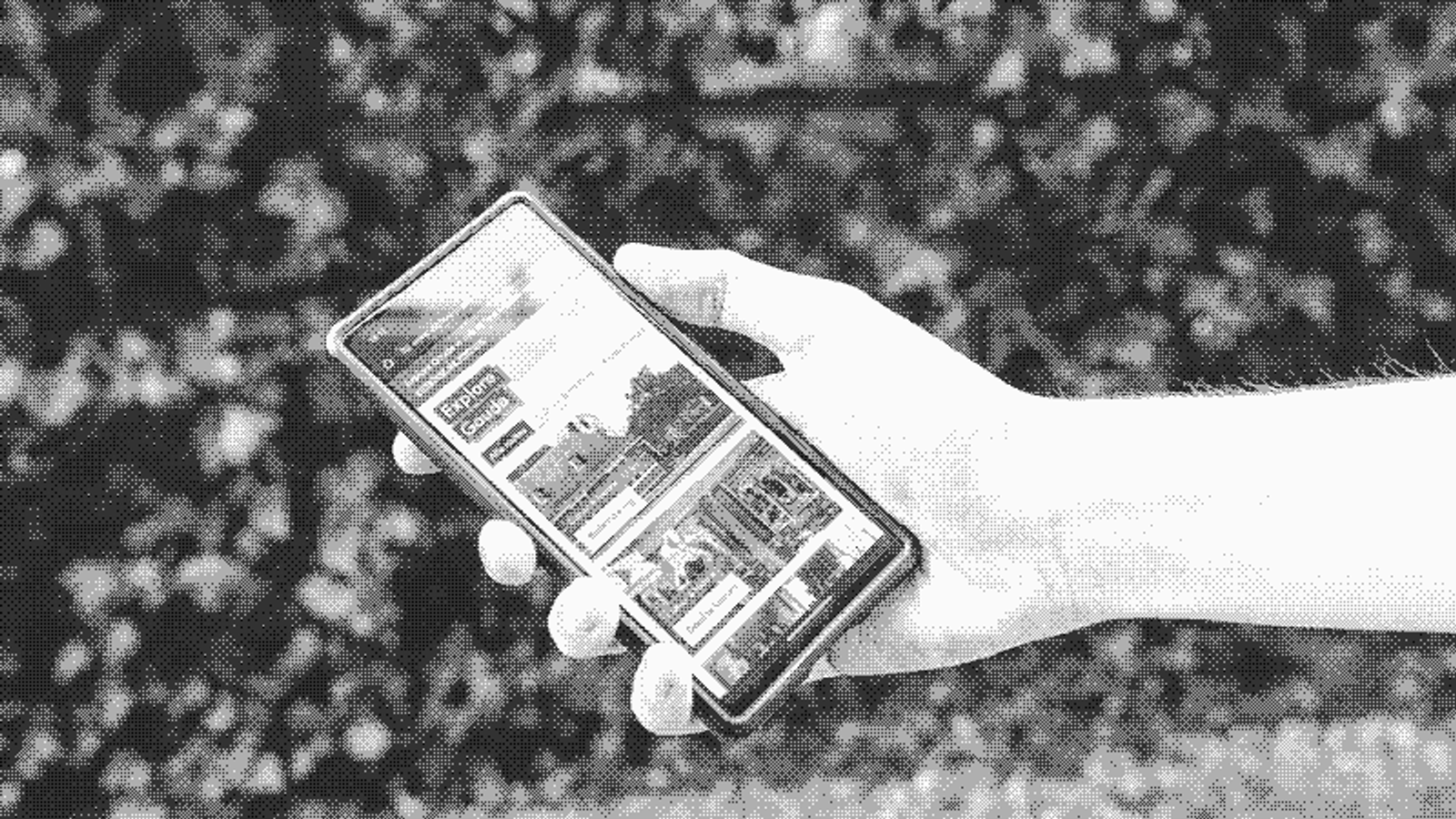 A hand holding a phone with the Explore Gouda web application open.