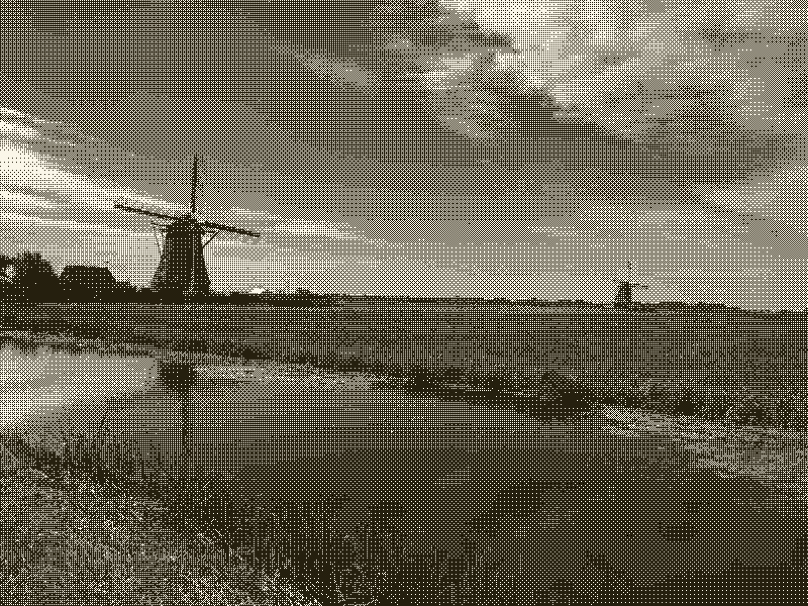 A photograph of two windmills behind a river in the Netherlands.